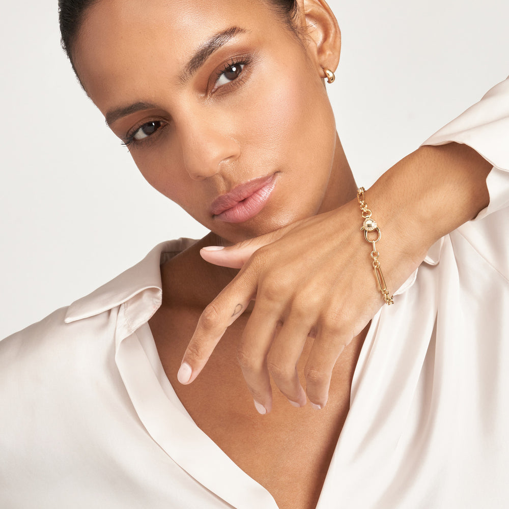 woman modeling the Hollow Paper Clip Bracelet with Diamond Lock on her wrist