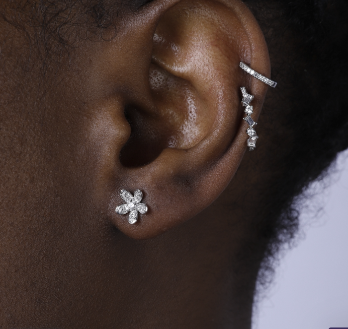 Modeled: our Diamond Flower Studs in 14K white gold, featuring a stunning center diamond stone. Shop now for a touch of elegance!"