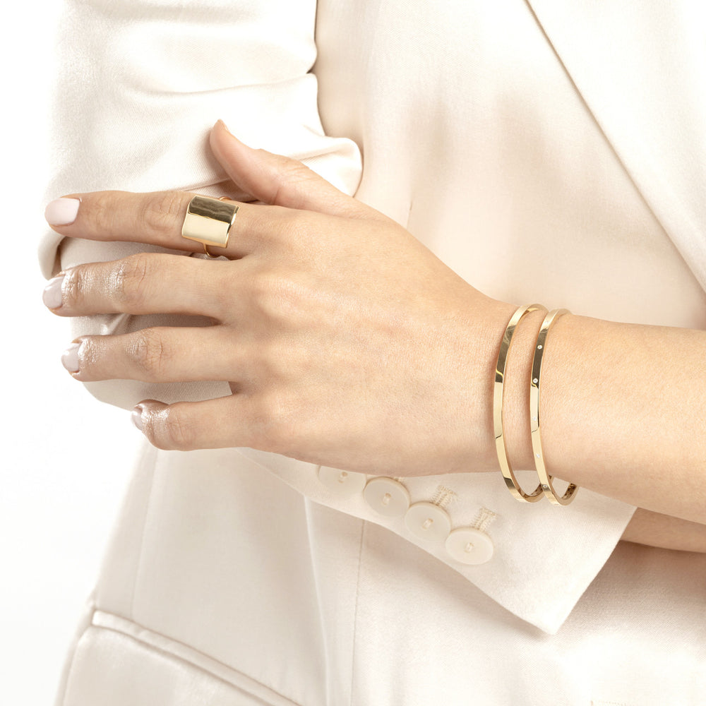 woman wearing two Plain Square Tube Bangle on her wrist
